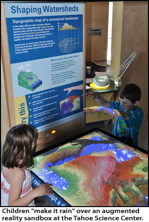 Children &quot;make it rain&quot; over an augmented reality sandbox at Tahoe Science Center